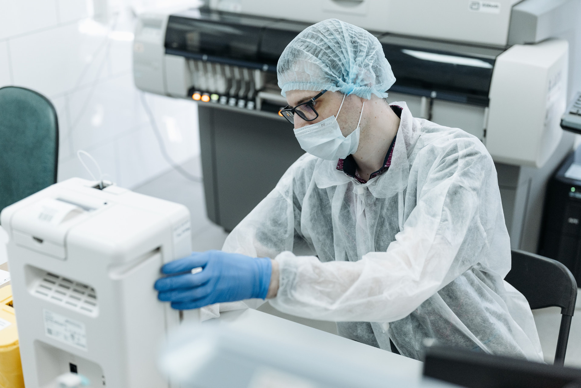 Clinical laboratory specialist operating structured data capture instrumentation in a research facility