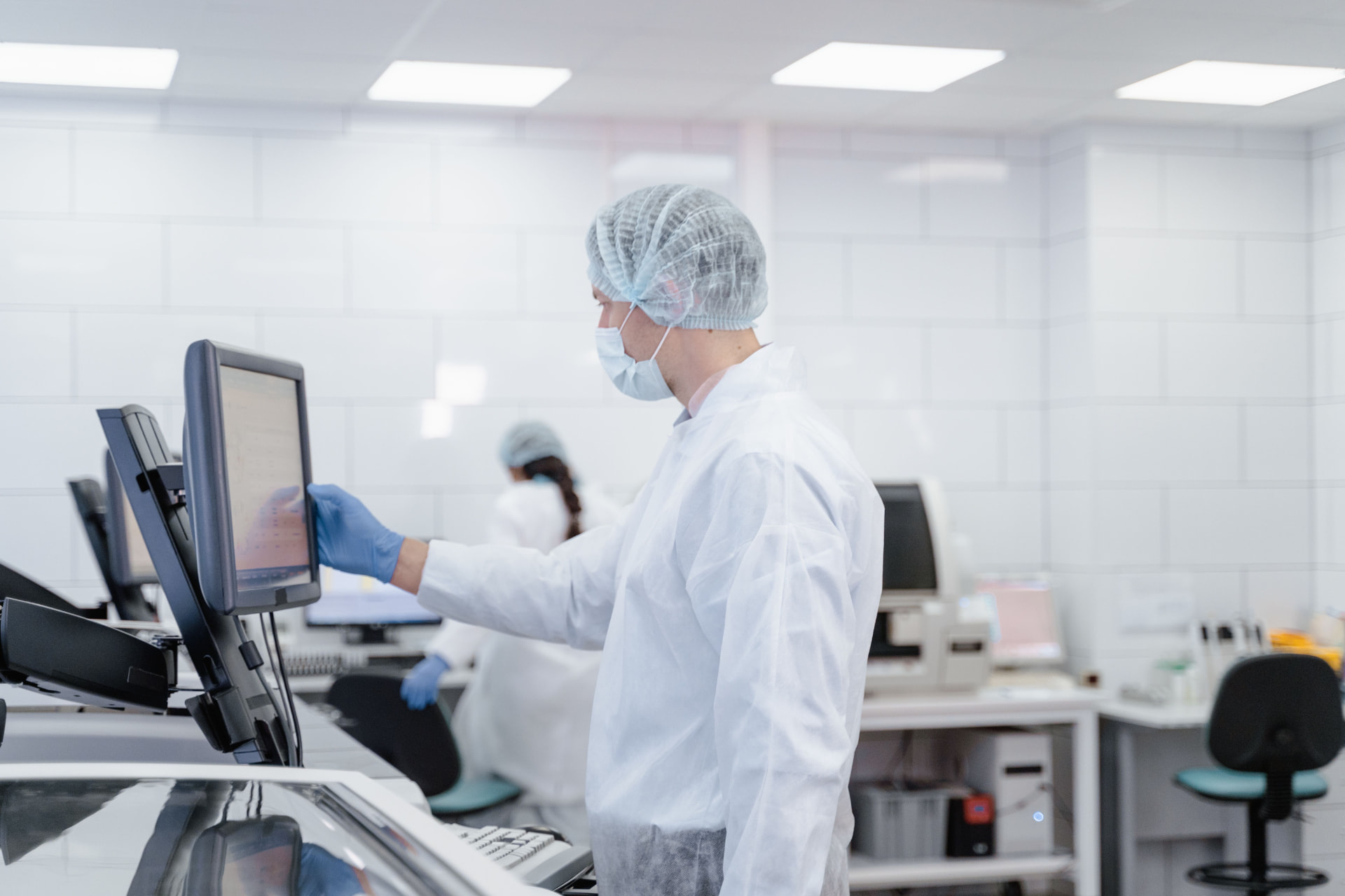 Laboratory scientist working at a touchscreen workstation