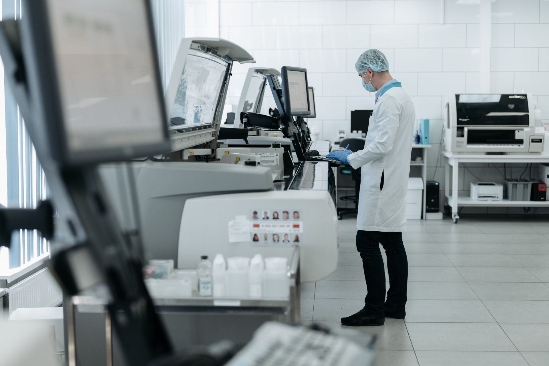 Clinical laboratory professional working with connected diagnostic systems